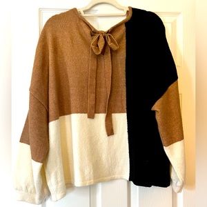 Block pattern sweater with bow back